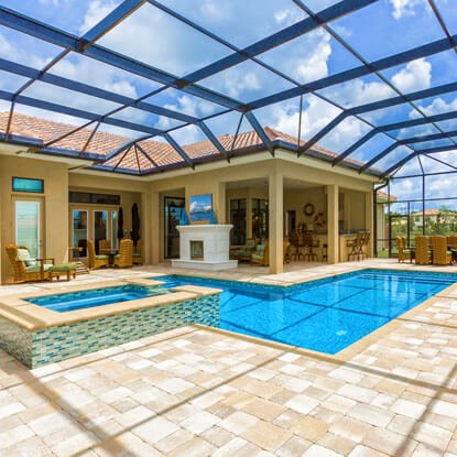 Fire feature and seating area beside a custom pool in Jacksonville, FL