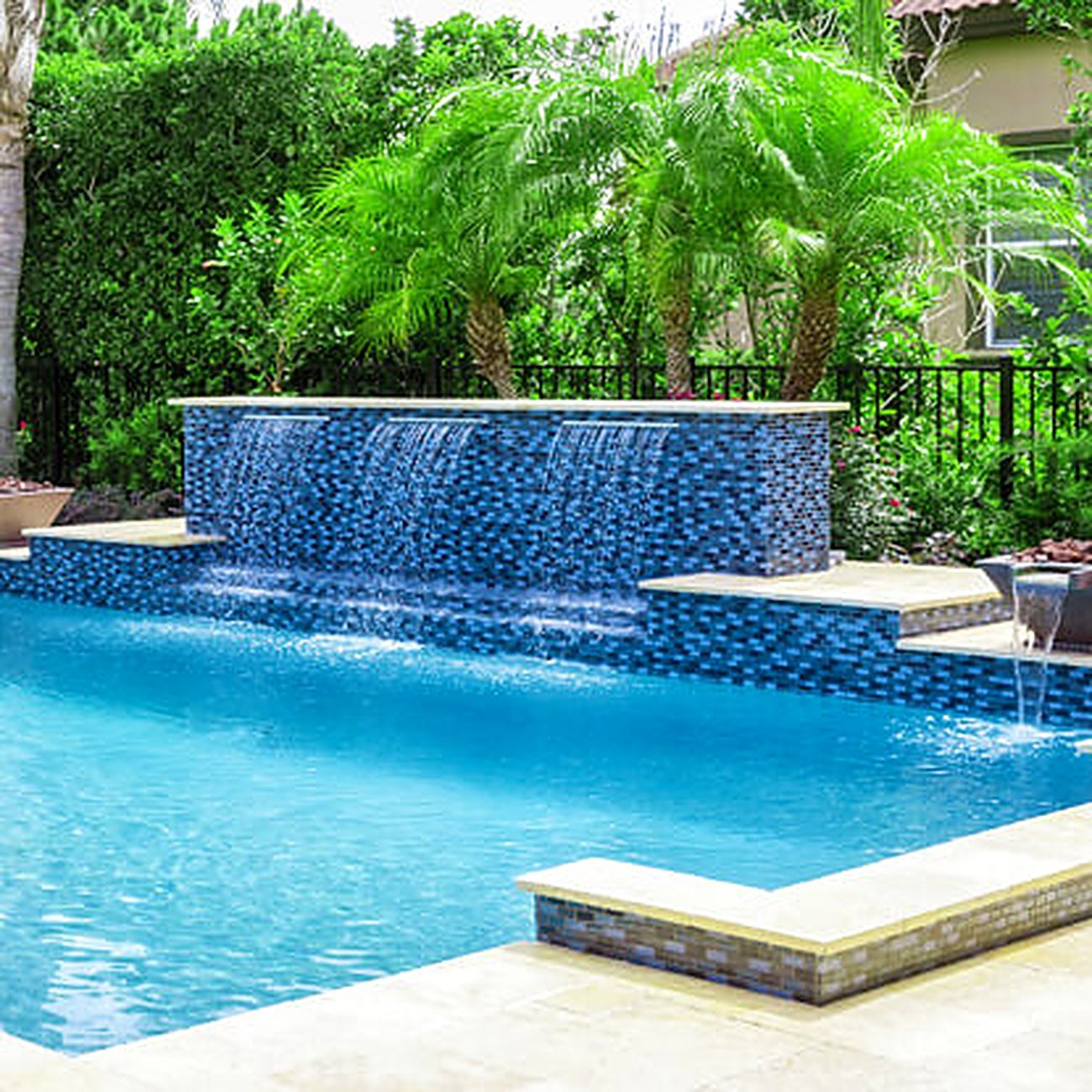 A custom water feature and spa built by Castle Pools in Southwest Florida.